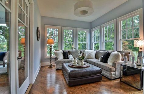 Cozy sunroom with light blue paint l shaped couch and laminate wood floors Indoor Sunroom, Cozy Sunroom, Small Sunroom, 4 Season Room, Four Seasons Room, Sunroom Furniture, Light Blue Paints, Sunroom Addition, Three Season Room