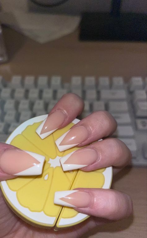 coffin shaped acrylic nails with a v shape white tip, holding a lemon to show them off. French Tip Nails Coffin Medium Length, V Tip White Nails, White Acrylic Nails Medium Length, French Tip Nails V Shape, V Line Nails, V Shape French Tip Nails, V Tips Nails Coffin, Coffin Chrome Nails, V Shape French Tip