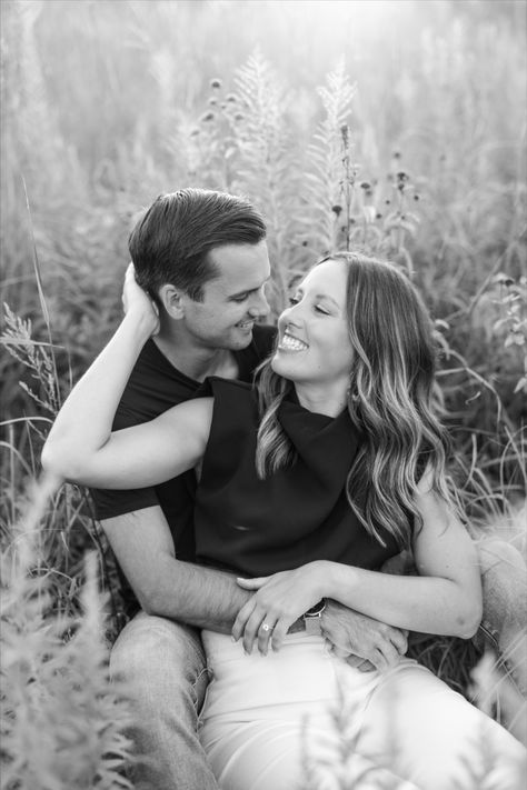 Couple sitting in tall grass field for engagement photoshoot Couple Poses Tall Guy, Couples Seated Poses, Couples Height Difference Poses, Couple Poses On Steps, Couple Poses Against Wall, Poses For Couples Short Guy, Poses For Couples Height Difference, Taller Woman Couple Poses, Couple Photoshoot Height Difference