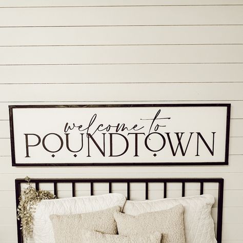 "welcome to poundtown  Free shipping in the continental U.S. White background with black lettering and your choice of frame color.  (to change the background or lettering color, put a note in the comment section at checkout) The 3D elements offer a bolder dimensional look and are made from 1/4\" laser cut boards, and are securely attached to the sign. The standard (not 3D) option offers a softer feel with all lettering painted. Available in 6 sizes: Shelf size - 7.5\" x 25.5\" x 1.5\" Twin size - 10.5\" x 37.5\" x 1.5\" Queen size - 13.5\" x 49.5\" x 1.5\" Queen Large -17.5\" x 49.5\" x 1.5\" King size - 13.5\" x 66\" x 1.5\" King Large - 17.5\" x 61.5\" x 1.5\" (give or take half an inch on all dimensions) Each sign has two claw hooks for easy hanging.  I will do my absolute best to get y Bed Signs Wall Art, Sign Over Bed Master Bedrooms, Above The Bed Decor Master, Diy Over The Bed Wall Decor Ideas Master Bedrooms, Over The Bed Sign, Welcome To Poundtown Sign, Guest Room Wall Decor Ideas, Wall Decor Bedroom Above Bed Master Suite, Poundtown Sign