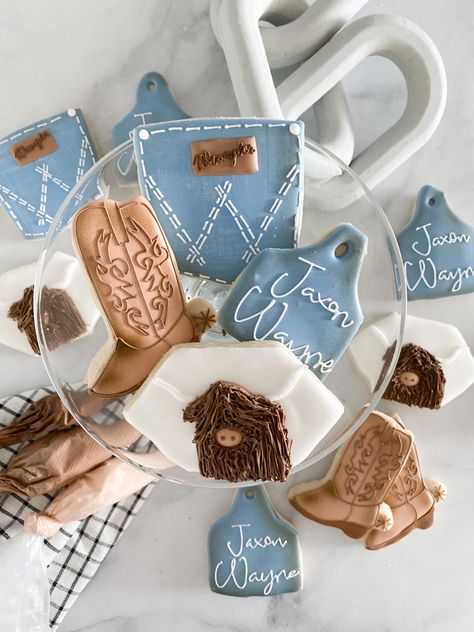 Holy Cow I’m One is such a cute first birthday theme! This cookie client emailed her inspiration photos and wanted just four designs. I think the cow is my favorite! #holycowimone #holycowbirthdayparty #decoratedcookies #sugarcookies #westerncookies #highlandcow #highlandcowcookies #royalicing #icingcookie #cowboytheme #cowgirltheme #firstbirthdayideas #wrangler Cow Ear Tag Cookies Decorated, Wrangler Cookies, Highland Cow Baby Shower Cookies, Highland Cow Cookies, Cow Baby Shower Theme, Mini Highland Cow, Cow Cupcakes, First Birthday Theme, Cow Cookies