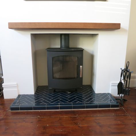 Stunning Mendip Churchill multi fuel stove with a blue herringbone tiled hearth Stove Fireplace Tiles, Fireplace With Tiled Hearth, Tiled Fireplace Herringbone, Tiling Fireplace Hearth, Fire Hearth Tiles, Log Burner Hearth, Wood Burner Hearth Ideas, Tiled Stove Fireplace, Tile Hearth Wood Stove