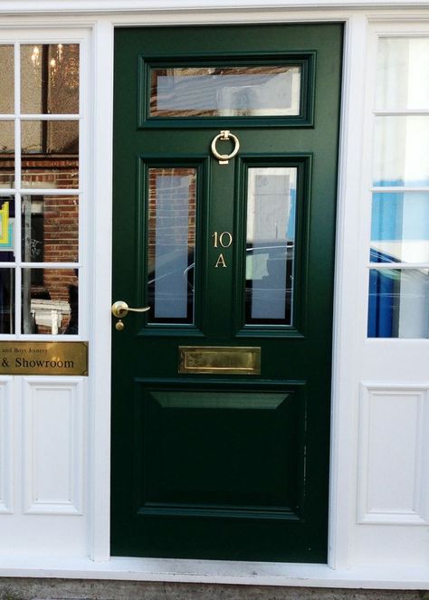 We manufactured and fitted this Victorian front door for our office in Putney. The door is made from Sapele Hardwood with top double glazed panels. The dark green spray painting contrasts very well with the white frames, and also compliments the brass door furniture. Laquer Black Front Door, Hunter Green Door Exterior, Green Painted Front Doors, Dark Green Front Door White House, Green Black Front Door, Dark Green Victorian House Exterior, Dark Green Front Door Colors, Emerald Green Front Door, Dark Green Front Door