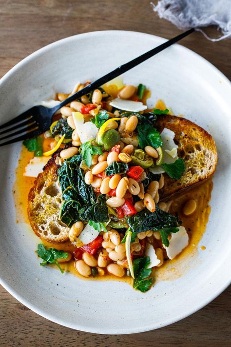 Brothy Beans over garlic-infused sourdough toast w/ lacinato kale, roasted peppers, olives, capers & lemon zest - an easy 30 minute meal! Brothy Beans, Beans And Greens, Lacinato Kale, Feasting At Home, Sourdough Toast, Garlic Toast, Crispy Garlic, 30 Minute Meals Easy, Beans On Toast