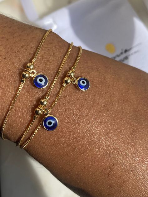 Gold Filled Evil Eye Bracelet Perfect as an accent bracelet or as a part of a stack with your other bracelets. 1mm dainty box Chain 6.5mm Evil Eye charm The evil eye bracelet is adjustable while the herringbone bracelet has a lobster claw. Both are made from 18K Gold Filled Brazilian Gold. If you would like to purchase the herring bone alone, use the link below. https://www.etsy.com/uk/listing/914777068/18k-gold-filled-herringbone-bracelet? If you have any questions, please send me a message and Evil Eye Bracelet Gold, Herringbone Bracelet, Brazilian Gold, Turkish Eye, Gold Armband, Jewelry Accessories Ideas, Jewelry Lookbook, Eye Bracelet, Gold Bracelet Chain