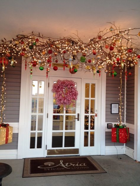 ....branches with lights and ornaments suspended from the ceiling.  This is an outdoor entryway.  (During the fall, pumpkins, etc. were hanging from the branches.) Branches With Lights, Christmas Ceiling Decorations Ideas, Christmas Ceiling Decorations, Christmas Branches, Hanging Christmas Lights, Candy Land Christmas Decorations, Hanging Christmas Tree, Christmas Hanging Decorations, Candyland Decorations