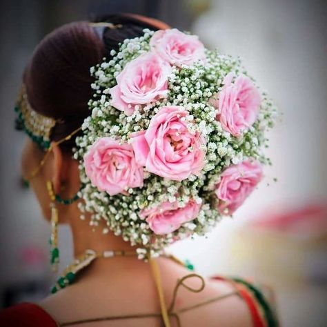 Cover the entire bun with a combo of light pink roses and baby's breaths for a decked-up look. #bridalhairstyling #bridalhairaccessories #bridalhairstyle #bridehair #bridalhairandmakeup #bridalhairstyles #bridalhairdo #bridalhair #shaadisaga #bride #bridalinspo #bridalinspiration Rose Bun, Bridal Hair Decorations, Bridal Hairstyle Indian Wedding, Unique Wedding Hairstyles, Flower Bun, Bridal Bun, Bridal Hairdo, Bridal Hair Buns, Indian Wedding Hairstyles