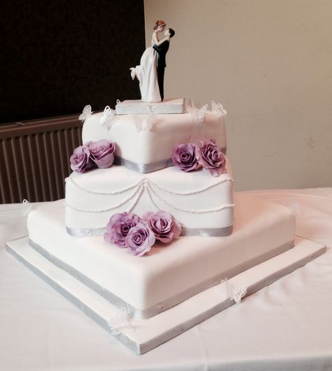 Simple, elegant, square offset wedding cake  Lilac flowers, roses Square Wedding Cakes Simple, Wedding Cakes Simple, Wedding Cakes Lilac, Budget Wedding Cake, Wedding Cake Simple Elegant, Cakes Elegant, Hummingbird Nest Ranch Wedding, Cakes Simple, Lace Princess Wedding Dresses