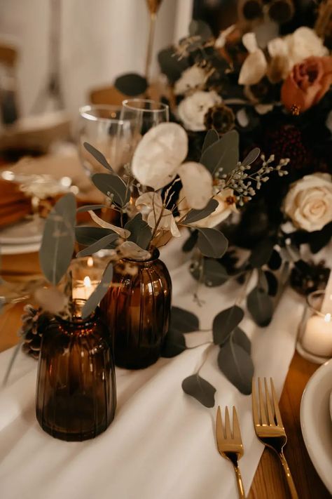 Centrepiece Flowers Decor Glass Jars White Rose December Wedding Ideas Megan Donati Photography #wedding #centrepiece #weddingflowers Table Decor Wedding Boho, Amber Glass Fall Centerpiece, Rustic Boho Wedding Table Centerpieces, Brown Glass Wedding Centerpieces, December Wedding Decor, Brown Wedding Table Decor, Wedding Decor 2024, Candles Centerpiece Wedding, Boho Christmas Wedding