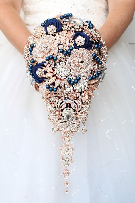 Navy blue and rose gold brooch bouquet. Teardrop navy blue and rose gold Wedding bouquet of brooches.  Bridal brooch bouquet. Cascading wedding bouquet Wedding flowes Prices for bridal bouquets depend on the size you choose. Measurements are made by the backside not across the top. Bouquet on the picture is 7" *11" size Matching accessories such as corsages, boutonnieres and bridesmaids bouquets can be made for you Rose Gold And Sapphire Wedding Colors, Navy Blue And Rose Gold Tuxedo, Dark Blue And Rose Gold Wedding, Red Navy And Gold Bouquet, Blue And Rose Gold, Blue Rose Gold Wedding, Navy Blue And Rose Gold Wedding Flowers, Rose Gold And Navy Blue Wedding, Rose Gold And Blue Wedding