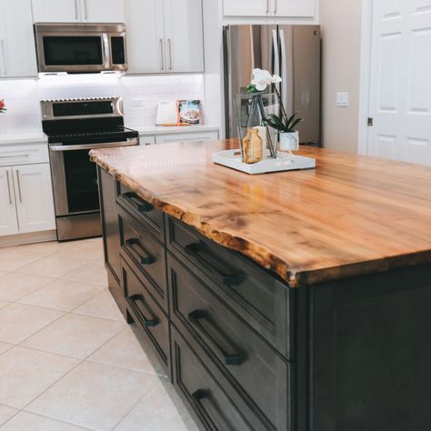 This natural wood live edge island counter top is the showcase of this beautiful kitchen. Wood Countertops Kitchen Island, Wood Island Countertop, Black Kitchen Countertops, Wood Countertops Kitchen, Kitchen Island Tops, Natural Wood Kitchen, Black Kitchen Island, Wood Countertop, Wood Kitchen Island