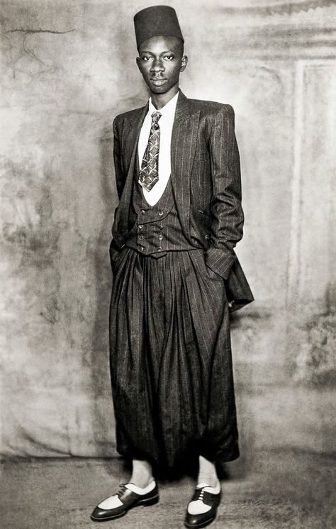 Mama Casset, Studio African Photo, Dakar, Senegal, c1950-60. The Elegant Senegal of the First Half of the 20th Century is an exhibition of images taken by renowned Senegalese photographer Mama Casset in the 1950s and an unknown photographer, on at the Círculo de Bellas Artes, Madrid, until 26 August Dandy Look, Costume Africain, Dakar Senegal, Zoot Suit, Americana Vintage, Vintage Black Glamour, Photographic Studio, African History, Style Noir