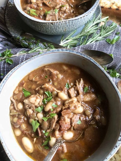 A rich slow-cooked casserole originating in the South of France, this White Bean Cassoulet with Pork & Lentils is a hearty bowl of goodness. Be sure to have some crusty bread handy for dipping in that delicious broth. A Hint of Rosemary #soups #stews #heartysoups #beans #lentils #pork #bacon #herbs #onepotmeal #ahintofrosemary Lean Pork, Slow Cookers, Cooking Basics, Crusty Bread, Fresh Rosemary, Hearty Soups, White Beans, Original Recipe, One Pot Meals