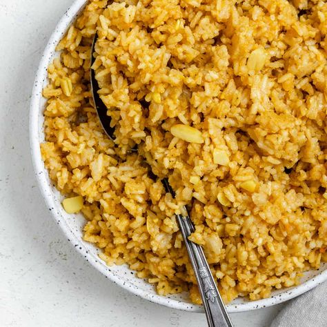 This golden garlic rice, AKA Spanish yellow rice (Arroz Amarillo), is fluffy, tender, vibrant thanks to annatto/achiote powder, and packed with aromatic garlic flavor—a delicious, versatile vegan side dish! Stove top, Instant Pot, and Rice cooker methods included! Chickpea Wrap, Rice Spanish, Garlic Rice Recipes, Quick Fried Rice, Grain Dishes, South American Dishes, Vegan Info, Garlic Fried Rice, 2023 Recipes