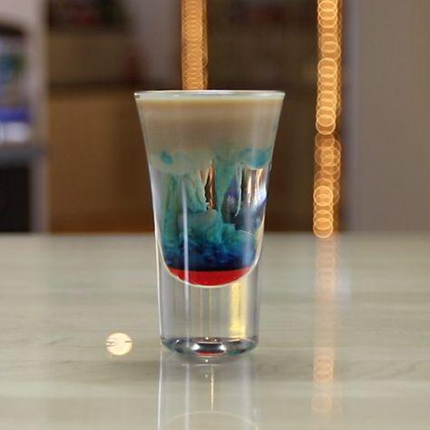 The Alien Brain Hemorrhage is guaranteed to explode your mind, even if you're not an extraterrestrial. This little shot of alien-looking snot contains Peach Schnapps, Irish cream, Blue Curaçao, and grenadine. Alien Cocktails, Zombie Brain Shot, Peach Cocktail Recipe, Fruity Shots, Brain Shot, Drink Image, Shooter Recipes, Peach Cocktail, Shots Alcohol