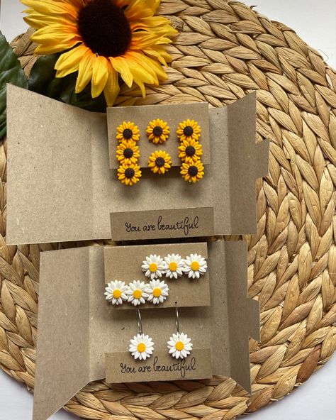 Set of hair clips and matching earrings of sunflower and daisy design in the handmade brown cute paper box with you are beautiful text written on it Polymer Clay Clips, Clay Earrings Clip On, Handmade Flower Polymer Clay Earrings, Diy Earrings Clay, Handmade Polymer Clay Flower Earrings For Gift, Fimo Earrings Flowers, Hair Clip Polymer Clay, Clay Clips, Air Dry Clay Earrings