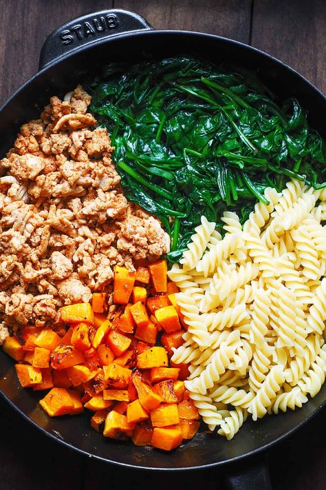 Ingredients for pasta in a cast-iron skillet: cooked ground turkey, cooked spinach, cooked pasta, roasted butternut squash Butternut Squash And Spinach Pasta, Ground Chicken And Butternut Squash, Turkey Squash Skillet, Turkey And Squash Recipes, Ground Turkey Protein Pasta, Butternut Squash With Ground Turkey, Butternut Squash And Turkey Recipes, Butternut Squash Turkey Recipes, Healthy Ground Turkey Pasta Recipes