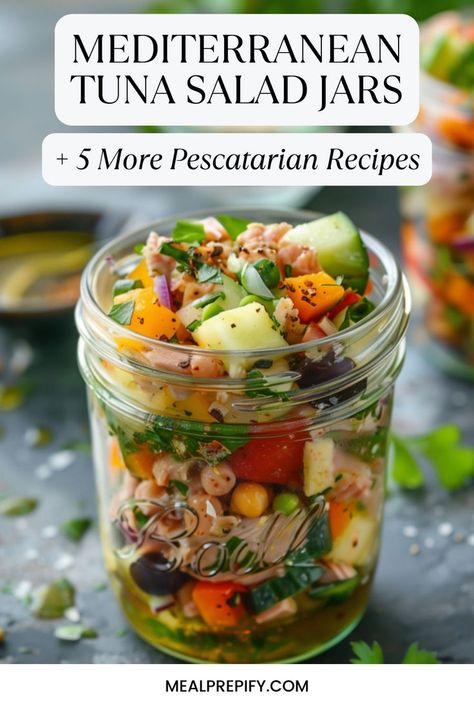 Colorful Mediterranean tuna salad jar packed with fresh veggies and chickpeas, showcasing a pescatarian recipe. Simple Summery Mediterranean Salad Jars, Mediterranean Jar Salad, Tuna Mediterranean Salad, Mediterranean Pescatarian Recipes, Mediterranean Tuna Recipes, Mediterranean Tuna Salad Recipe, Healthy Pescatarian Recipes, Recipes For Seafood, Salad Jars