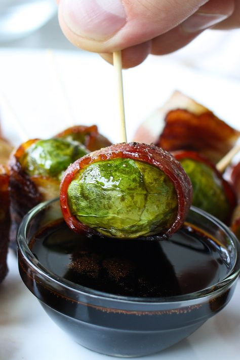 A bacon wrapped brussel sprouts being dipped into a balsamic dressing for the perfect hors d'oeuvre Bacon Wrapped Brussel Sprouts, Radish Recipes, Elegant Appetizers, Cayenne Pepper, Bacon Wrapped, Brussels Sprouts, Holidays Christmas, Brussel Sprouts, Skewers