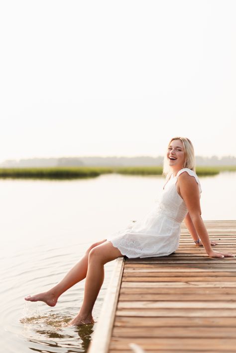 white dress green floral pattern dress short heels dock by the water low country marsh boat ramp Doc Picture Ideas, Dock Photoshoot Ideas, Senior Pictures On A Dock, Senior Picture Ideas Dock, Boat Dock Senior Pictures, Senior Photos On A Dock, Senior Photos By Water, Senior Pictures At The Lake, Boat Dock Photoshoot