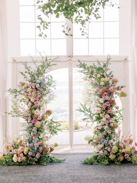 Ceremony Flowers Aisle Entrance, Statement Wedding Florals, All Pink Wedding Flowers, Pastel Wedding Arch Flowers, Floral Arch Wedding Indoor, Deconstructed Flower Arch, Colorful Flower Arch, Sage Green Wedding With Colorful Flowers, Pastel Floral Arch