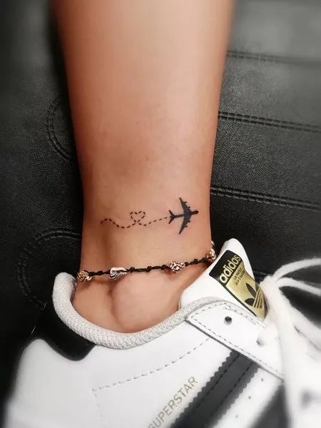 Little Airplane Tattoo, Tattoo Ideas For Travelers, Tattoo On Ankle For Women, Small Plane Tattoo, Small Airplane Tattoo, Airplane Tattoo Design, Plane Tattoo Design, Small Ankle Tattoos For Women, Ibiza Tattoo