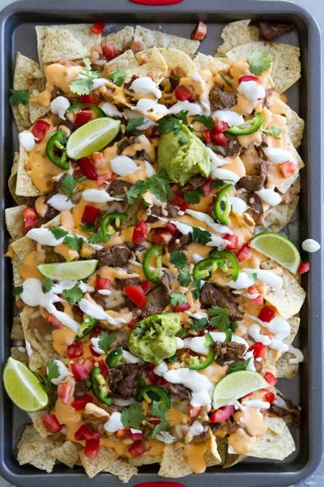 Looking for the best nachos supreme recipe? These Sheet Pan Steak Nachos Supreme have tortilla chips that are topped with a creamy cheese sauce, beans, seasoned steak and all kinds of toppings. Appetizer Nachos, Nacho Supreme, Nachos Supreme Recipe, The Best Nachos, Sheet Pan Steak, Seasoned Steak, Best Nachos, Nacho Recipes, Steak Nachos