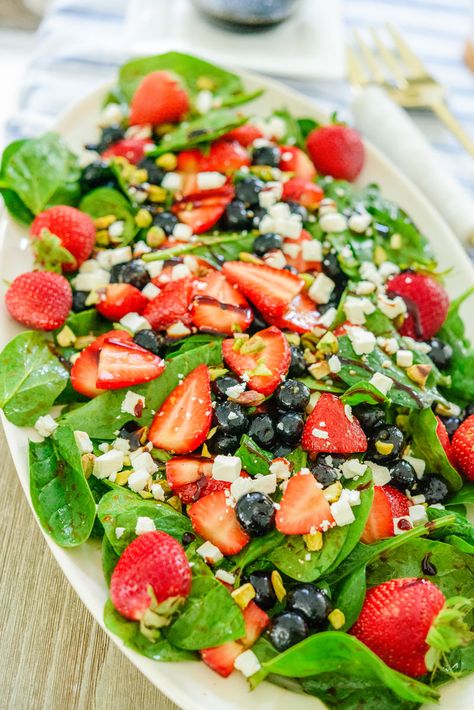 This Strawberry Spinach Salad features plump blueberries, feta cheese, and crushed pistachios topped with a sweet balsamic vinaigrette. It's incredibly easy Broccoli And Strawberry Salad, Strawberry Blackberry Spinach Salad, Strawberry Blueberry Salad, Summer Berry Salad, Salad With Strawberries And Blueberries, Strawberry Blueberry Spinach Salad, Spinach Strawberry Salad Poppyseed, Spinach Salad With Strawberries And Blueberries, Blueberry Spinach Salad