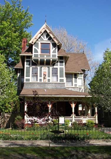 Franklin W. Caulkins House  415 Franklin Street, Buffalo, N. Y.  Erected:1882  Architect:Franklin W. Caulkins  Style:Stick / Eastlake        Asymmetrical      The Eastlake porch supports its roof on massive knobbed posts and a spindle balustrade interrupted by decorative cut-outs Stick Eastlake House, Eastlake House, New York Houses, Porch Supports, Modern Log Cabins, Victorian Modern, Buffalo New York, Craftsman Bungalows, Log Cabins