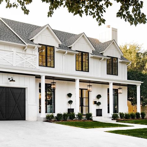 Beautiful white modern colonial exterior. Columns, black garage door. Large windows. Siding and brick. Modern Colonial Farmhouse Exterior, Modernizing Colonial Exterior, Modern Farmhouse Colonial Exterior, White And Black Colonial Exterior, Black And White Colonial Exterior, Colonial House Renovation, Modern Colonial Architecture, Modern Colonial Exterior House Design, Colonial Chic Exterior