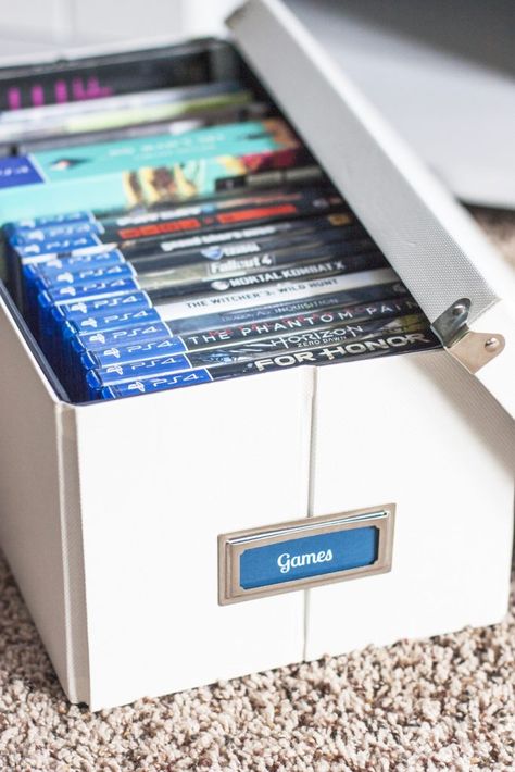 Love this organizing solution for a tv stand! Organize video games and all of the accessories inside pretty storage boxes. These Pop 'N Boxes are so cool because they look nice and fold flat when not used. I love how this blogger added bookplate labels to them! That painted TV stand plus the storage boxes made such an improvement! Board Games Ideas, Dvd Storage Ideas, Painted Tv Stand, Video Game Organization, Pretty Storage Boxes, Video Game Storage, Kids Storage Boxes, Swivel Tv Stand, Cd Storage