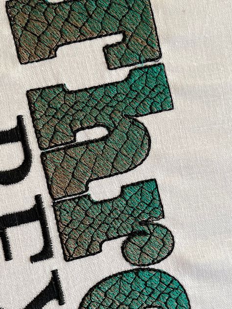 T-rex Rex gradient ombre Font dinosaur skin alphabet fill stitch Jurassic Font A-Z and numbers machine embroidery designs 1.5 thru 3.5″ boys This is a fill stitch font that has 3 layers: the first two layers make the ombre effect, mix green and brown colors and get stunning effects the third layer is the skin pattern, which gives the true Trex look and the last one is an outline. Included uppercase and lowercase letters, numbers 0-9 and punctuation & . , - Sizes: 1.5 inches 1.7 inches 2 inches 2 Embossed Printing, Ombre Gradient, Diy Tattoo, Shirt Print Design, Free Machine Embroidery Designs, Embroidery Fashion, Embroidery Techniques, Stitch Design, Embroidery Projects