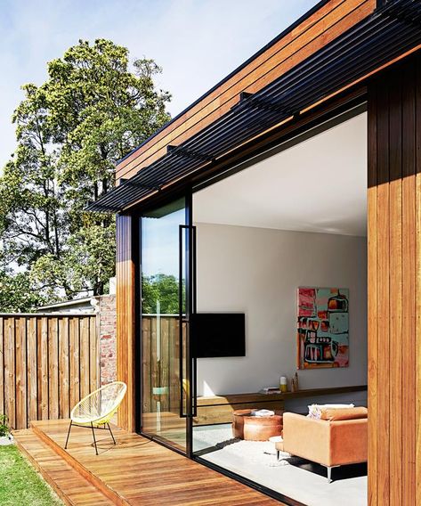 Floor-to-ceiling double-glazed sliding doors open onto the deck to give the open-plan living area an indoor-outdoor vibe. Custom black powdercoated louvres provide some shade.| Photo: Sharyn Cairns | Styling: Emily Ward | Story: Real Living Black Sliding Door, Stacker Doors, Barn Door In House, Sliding Doors Exterior, Homes To Love, Melbourne House, Door Design Modern, Interior Barn Doors, Barn Doors Sliding