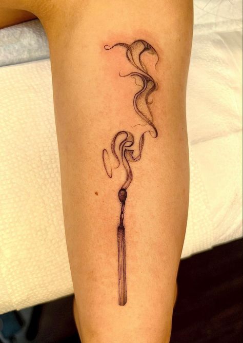 Tattoo of a half burnt match with smoke rising from it in a ribbon style placed on a person’s lower leg Two Matches Burning Tattoo, Burning Match Tattoo Design, Survive Tattoo Symbols, Burning Paper Tattoo, Burned Match Tattoo, Hands Holding Fire Tattoo, Smokey Match Tattoo, Matchstick Tattoo Meaning, Match Burning Tattoo