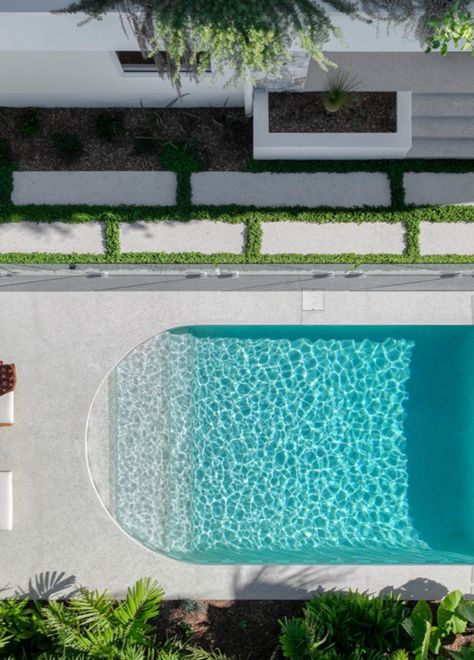 Everything about this pool is inviting. The shape, the water line checker tile, and the colour of the water. I just want to dive in! Curved Swimming Pool, Irregular Shape Swimming Pool, White Swimming Pool Tiles, White Tile Pool Waterline, Pool Area Ideas, Pool Colours Water, Portugal Resorts, Pool And Pool House Ideas, Backyard Pool Design