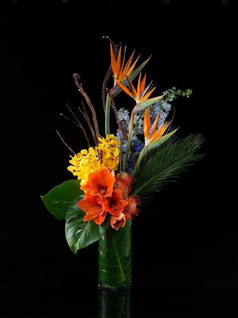 Orange, Yellow & Red Flowers With Tropical Feel Red Orange Yellow Flower Arrangement, Red Orange Flower Arrangements, Tropical Thanksgiving, Tropical Wedding Centerpieces, Yellow Flower Arrangements, Black Tablecloth, Flower Installation, Shopping Party, Orange Wedding