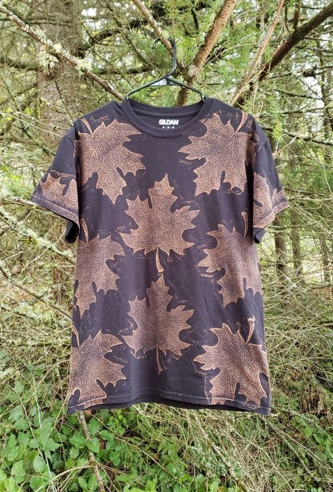 "❧Hand carved fall leaves printed with bleach on a black T-shirt ❧ This is a MADE TO ORDER listing and will take 1-8 weeks to ship out. ❧Please note that due to the nature of the printing process, there may be slight variations to the print itself. ❧ SIZE CHART (Unisex/men's sizing,measured flat across chest and from shoulder to bottom hem): S- 17\" Chest, 24\" Long M- 19\" Chest, 28\" Long L- 21\" Chest, 28\" Long XL- 23.5\" Chest, 30\" Long 2XL- 25\" Chest, 30\" Long ❧Fabric is cotton and prov Bleach Printed Shirts, Bleach Printing On Fabric, Bleach Art On Clothes, Bleach Pattern Shirt, Fall Grunge Bleached Tops, Bleach Painting Hoodie, Bleach Leaf Hoodie, Bleach Leaves Hoodie, Leaf Bleach Printing