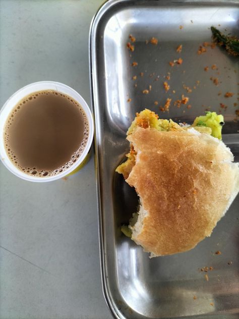 Vada Pav, also known as Mumbai Burger, is a popular street food in India, especially in the state of Maharashtra. It consists of a spicy potato fritter (batata vada) sandwiched between two slices of bread (pav), typically served with chutneys made from tamarind, coriander, and garlic. The pav is usually toasted with butter for added flavor. It is a quick and tasty snack, often enjoyed with a cup of chai (tea), making it a popular choice for breakfast or as a mid-day snack. Batata Vada, Potato Fritters, Tea Making, Chai Tea, Slice Of Bread, Yummy Snacks, Chutney, Street Food, Mumbai