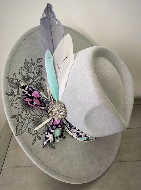 ' Horses and Flowers'- made from premium faux suede in gray with cotton and suede banding. She is wild and bold! I only use the best materials and each hat is crafted with love. Each hat is custom designed. Each hat is unique and different; no two hats are the same. This hat has an adjuster inside the crown that allows 22-22.9 inch circumference; she fits most sizes! Brim length 3.75" Height: 4.72" Due to the custom nature of my hats, and because of various sanitary concerns,hats are NOT returna Cheap Western Style Felt Hat For Country Events, Cheap Curved Brim Felt Hat For Festivals, Cheap Short Brim Fedora For Western-themed Events, Luxury Rigid Felt Hat For Western-themed Events, Luxury Handmade Felt Hat For Western-themed Events, Luxury Artisan Felt Hat For Western-themed Events, Luxury High Crown Western Felt Hat, Cheap Curved Brim Hat As Gift, Cheap Wide Brim Fedora For Country Events