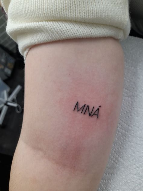 Black tattoo in typewriter font reads, MNÁ aka women in irish Tiny Irish Tattoos For Women, Grá Tattoo Irish, Irish Tattoos For Women, Feminism Tattoo, Ireland Tattoo, Irish Tattoos, Irish Women, Cute Little Tattoos, Dainty Tattoos