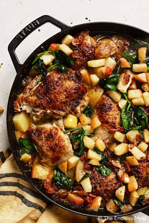 Savor the comforting flavors of fall with this one-pan apple chicken recipe! Crispy-skinned chicken is cooked with bacon, apples, potatoes, and spinach in a honey mustard sauce. This simple and healthy meal is always a crowd-pleaser, and it's ready in just over an hour! #theendlessmeal #chicken #apple #apples #applechicken #onepan #glutenfree #paleo #healthydinner #glutenfree Apple Chicken Skillet, Chicken Apple Dinner Recipes, Dinner Paleo Recipes, Fall One Pan Recipes, Chicken With Apples And Onions, Dinner Ideas With Apples, Apple Butter Chicken Recipe, Chicken Pear Recipes, Nourishing Fall Meals