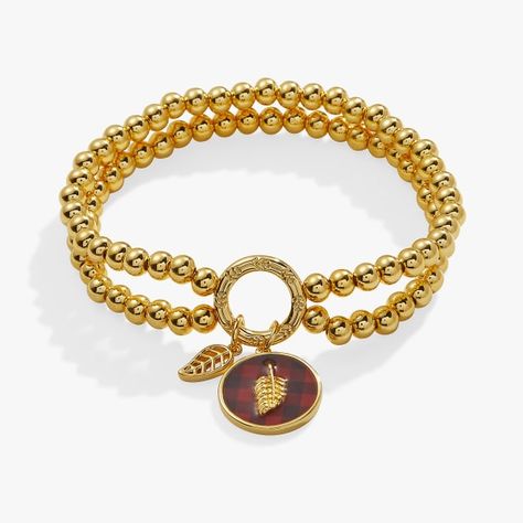 Nothing says Fall quite like a buffalo plaid print. Elevate your autumn stack with this dual-layered gold beaded stretch charm bracelet featuring a circular charm with a coated buffalo plaid print design and a gold autumn leaf detail. Fits wrist sizes 6.75’’ to 8’’ Finishes: Shiny Gold Nickel-free Alex And Ani Bracelets, How To Clean Metal, Autumn Leaf, Elephant Charm, Gold Birthday, Cross Bracelet, Unique Jewelry Designs, Halloween Jewelry, Jewelry Unique