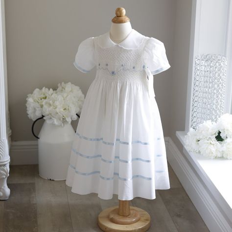 This Gorgeous Strasburg Smocked Heirloom Dress In White Size 2 Has Baby Blue Satin Trim. No Longer In Production And New With Tags Makes It A Treasure!! The Hand Smocked Bodice Has A Sweet Lattice Design With Hand Embroidered Baby Blue Details Including Rosettes With Seed Pearl Centers. White Seed Pearls Also Adorn The Waistline Making It Ever-So-Sweet!! The Puff Sleeves Are Trimmed In A Blue Satin Ribbon. The Collar Is A Sheer Organza With A White Embroidered Scalloped Edge, A Unique Collar For Spring Baptism Dress With Smock Detail, Spring Baptism Dress With Smocked Back, Blue Smocked Dress With Smocked Cuffs For Playtime, Summer Baptism Smocked Dress With Smocked Back, Blue Embroidered Cotton Smocked Dress, Baby Heirloom, Subscribe My Youtube Channel, Girls White Dress, Heirloom Dresses