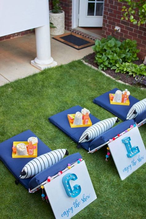 We've put together a list of everything you need for an amazing backyard movie night, from the best outdoor projector to the ultimate movie snacks. Once you have everything you need for your outdoor movie night, you'll be all set to make it a regular summer tradition.  #outdoor, #backyard, #movie, #movies, #DIY, #How-To, #summer, #yard, #family-night, #games, #culture, #decor, #shopping-guide Outdoor Party Seating, Movie Night Seating, Diy Backyard Movie, Backyard Movie Night Party, Diy Backyard Movie Night, Movie Seats, Diy Movie Night, Outdoor Movie Party, Outside Movie