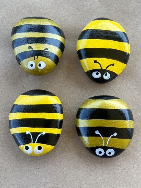 Hand painted, garden BEE rocks. These bees are 2-3 inches and each rock is unique. The rocks are not handmade from concrete so each rock may be slightly different than pictured. Each rock will vary slightly as I do not use stencils or stamps. I am happy to do custom colors not pictured or themed bees for celebrations and holidays. Rainbow Rock Painting Ideas, Cute Bee Painting, Stone Painting Animals, Rock Painting Garden, Things To Paint On Rocks, Rock Bugs, Cute Rock Painting Ideas, Bee Rocks, Garden Crafts For Kids