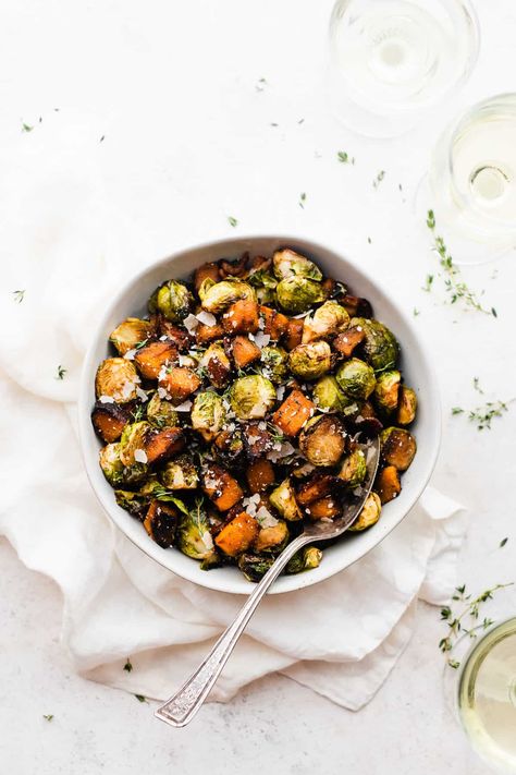 Meet the easiest ever Thanksgiving side dish! Brussels sprouts and butternut squash are seasoned with olive oil, sage, thyme, and maple syrup. Roast everything together with some bacon - yes, it all cooks together! - until tender and caramelized. Veggies never looked or tasted so good! #thanksgivingsides #thanksgivingrecipes #glutenfreethanksgivingrecipes #glutenfreesides #brusselssprouts #bacon #maple #butternutsquash #easysidedish #airfryerthanksgiving #bluebowlrecipes | bluebowlrecipes.com Butternut Squash With Bacon, Brussels Sprouts And Butternut Squash, Gluten Free Thanksgiving Recipes, Quick Lunch Recipes, Thanksgiving Side Dish, Gluten Free Sides, Roasted Brussels Sprouts, Thanksgiving Side, Quick Weeknight Meals