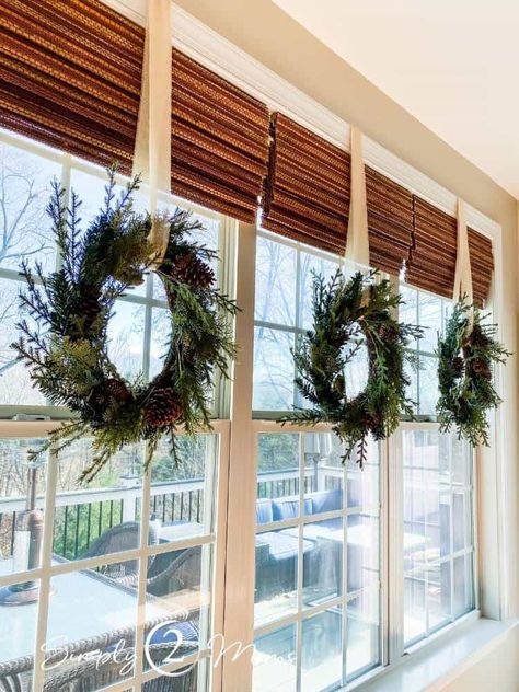 Window Sill Christmas Decorations, Christmas Decor Sunroom, Christmas Wreath Window Indoor, Wreaths Over Windows, Decorating Indoor Windows For Christmas, Indoor Christmas Wreaths Window, Wreaths On Interior Doors, Christmas Wreath Kitchen Window, Christmas Wreath Above Garage Door