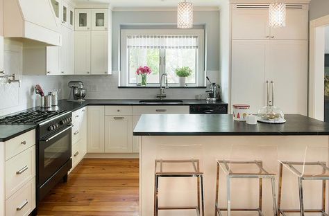 Cream and black kitchen features a pair of crystal beaded column pendants illuminating a cream kitchen island topped with soapstone lined with CB2 Vapor Counter Stools. Slate Kitchen Countertops, Cream And White Kitchen, Slate Kitchen, Cream Kitchen Cabinets, Slate Countertop, Bold Kitchen, Kitchen Countertop Materials, Black Countertops, Black Appliances