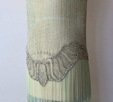 Rare and arrestingly beautiful 1920s celadon sheer silk dress with silvery vertical beading, beaded neckline at both the front and back, sheath shape with beaded hip and almond shaped velvet leaves embellishing the skirt. No closures, slips on easily over the head. Artemis Dress, Art Deco Embroidery, Vintage 20s Dresses, 20s Dress, Velvet Leaves, Historic Fashion, Vintage 1950s Dresses, 1920s Dress, Beaded Neckline