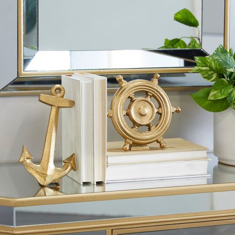 Show off a lavish home office vibe as you display this set of gold nautical sculptures that blends well with dark-toned desks and other metal accent pieces. Create a balance surface space and added dimensions with this beautifully crafted sculpture. Nautical Table Decor, Mexico Decor, Ship Steering Wheel, Nautical Table, Open Table, Anchor Decor, Nautical Anchor, Nautical Fashion, Nautical Decor